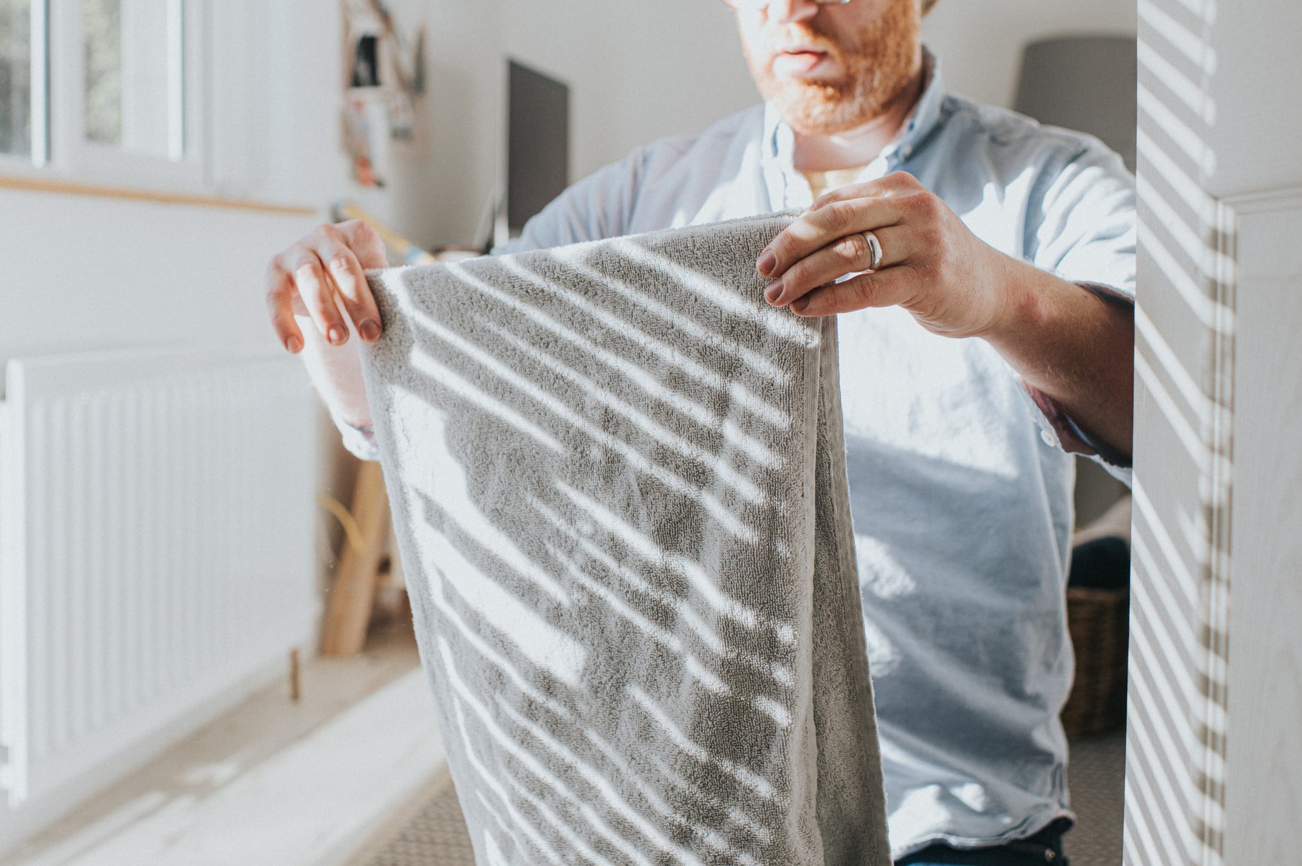 man folding towel