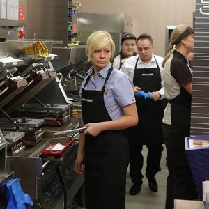 Fast food workers in the kitchen cooking