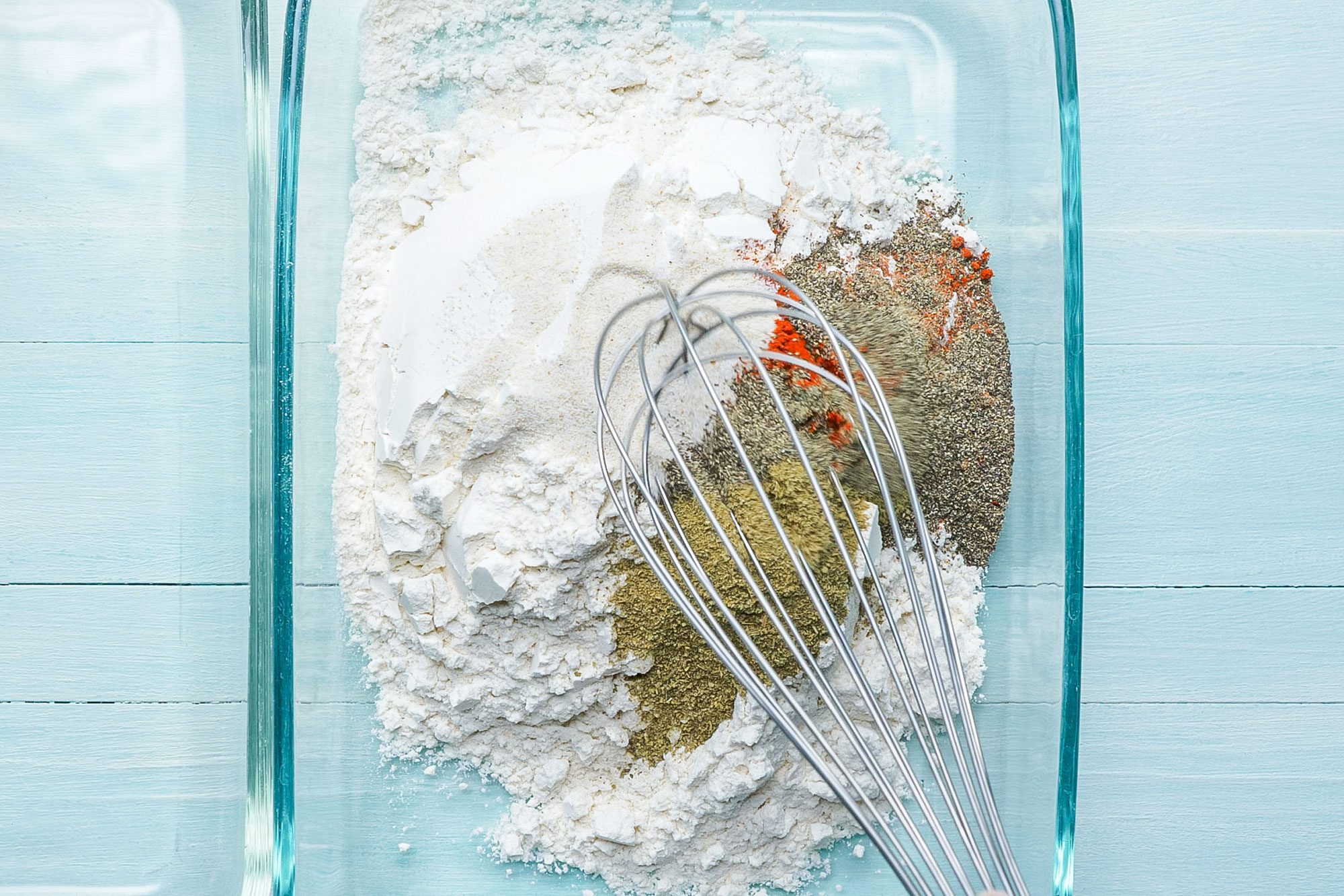 Mixing Dry Ingredients in a Glass Rectangular Bowl to make Crispy Fried Chicken