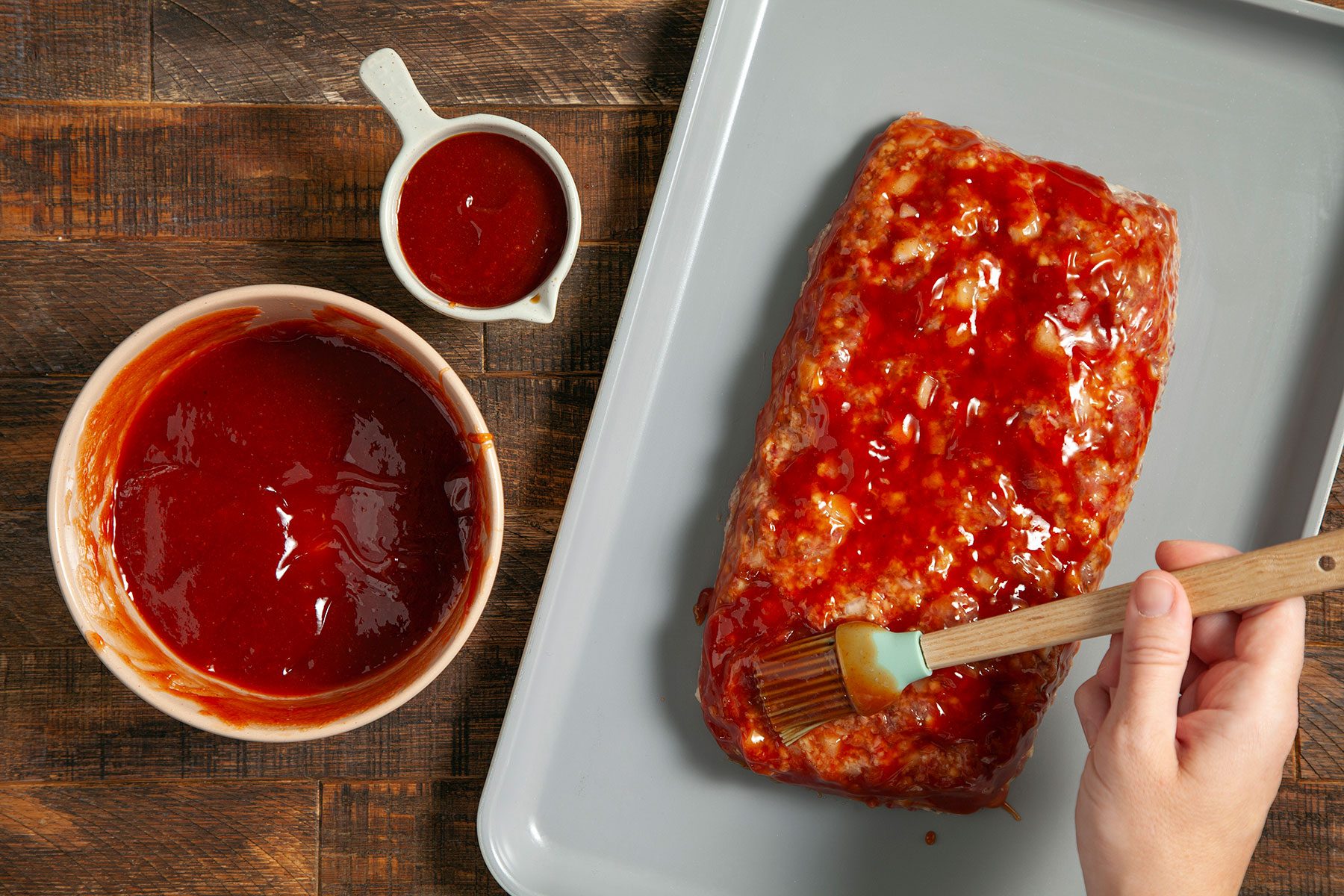 Brushing sauce to meat