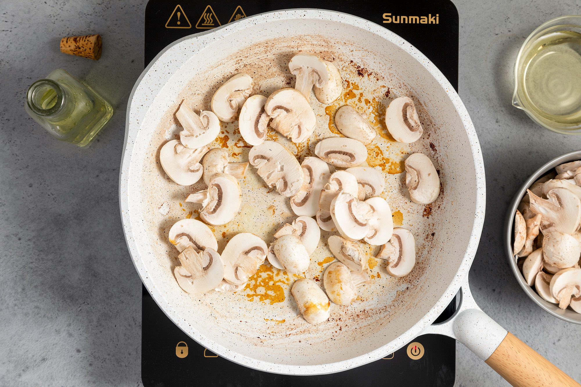 Sautéing Mushrooms In A White Non Stick Skillet on Induction Cooktop