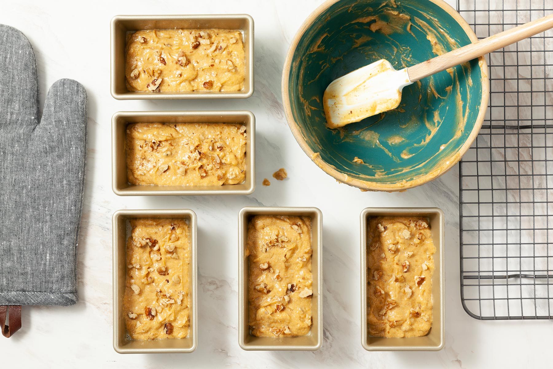 A Group of Rectangular Pans With Batter in Them