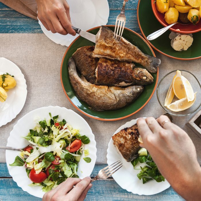 Dinner with fried fish, potatoes and fresh salad; Shutterstock ID 400166998