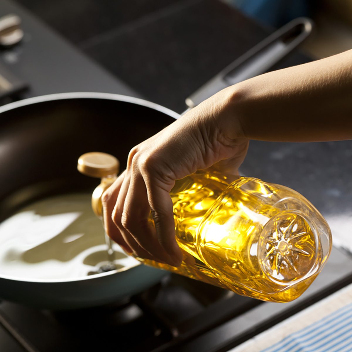 Pouring vegetable oil into frying pan