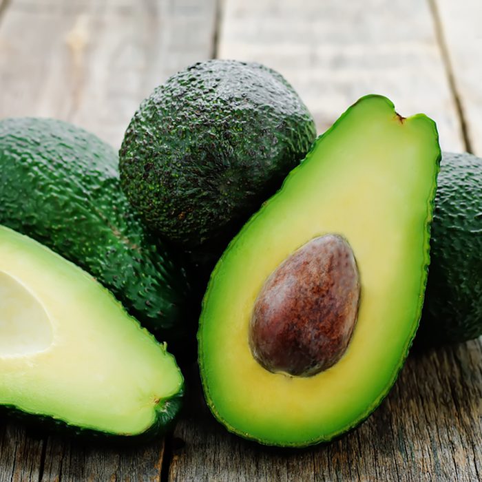 avocado on a dark wood background. tinting. selective focus