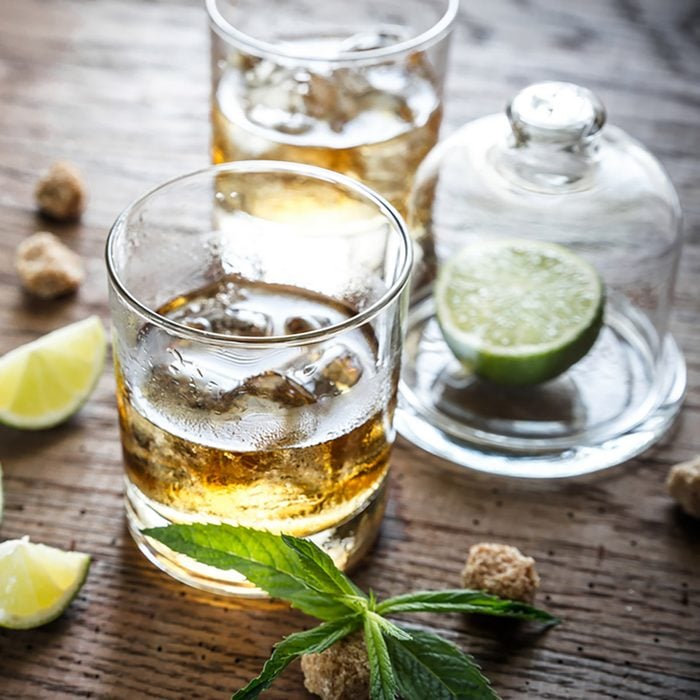Glass of rum on the wooden background