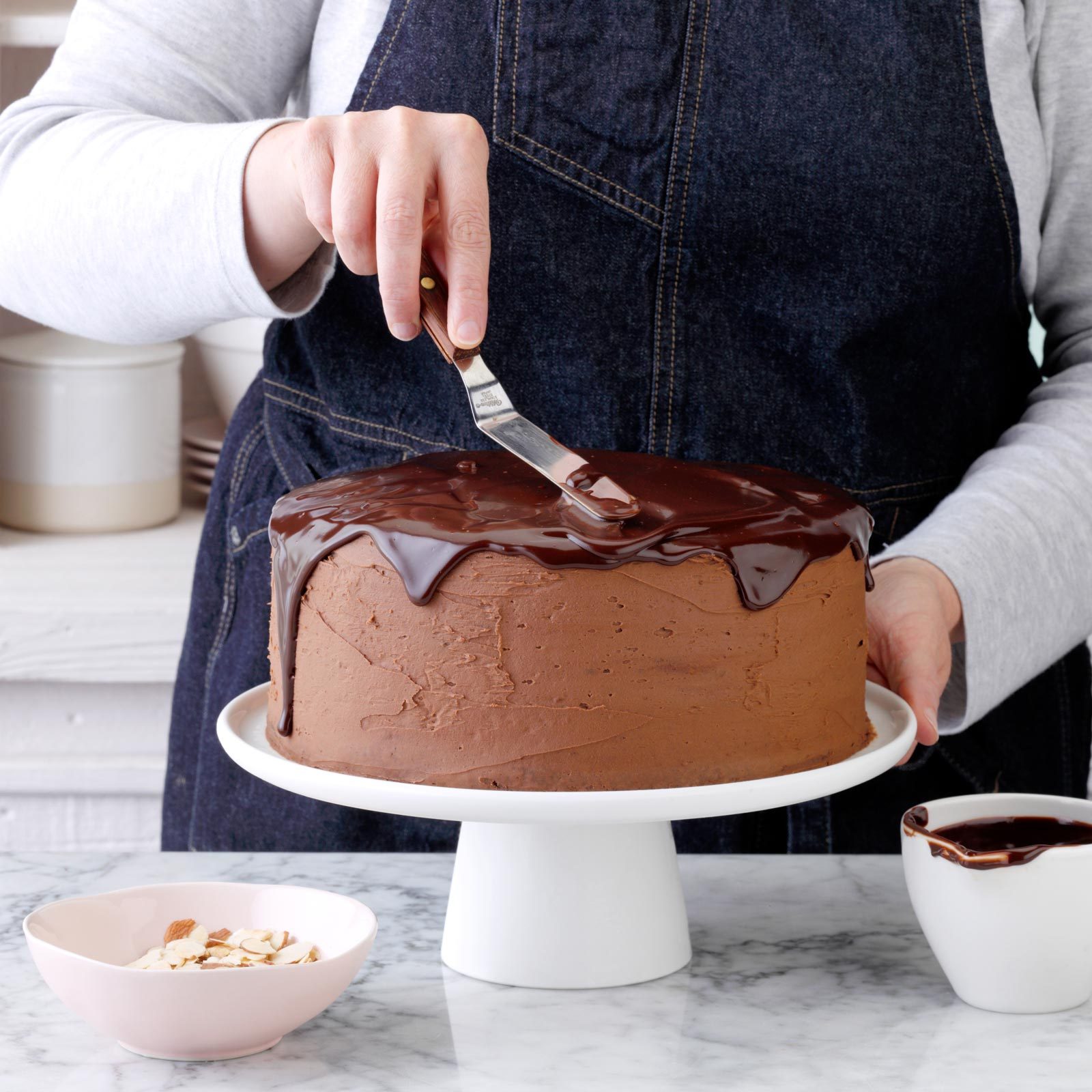 frosting a chocolate cake
