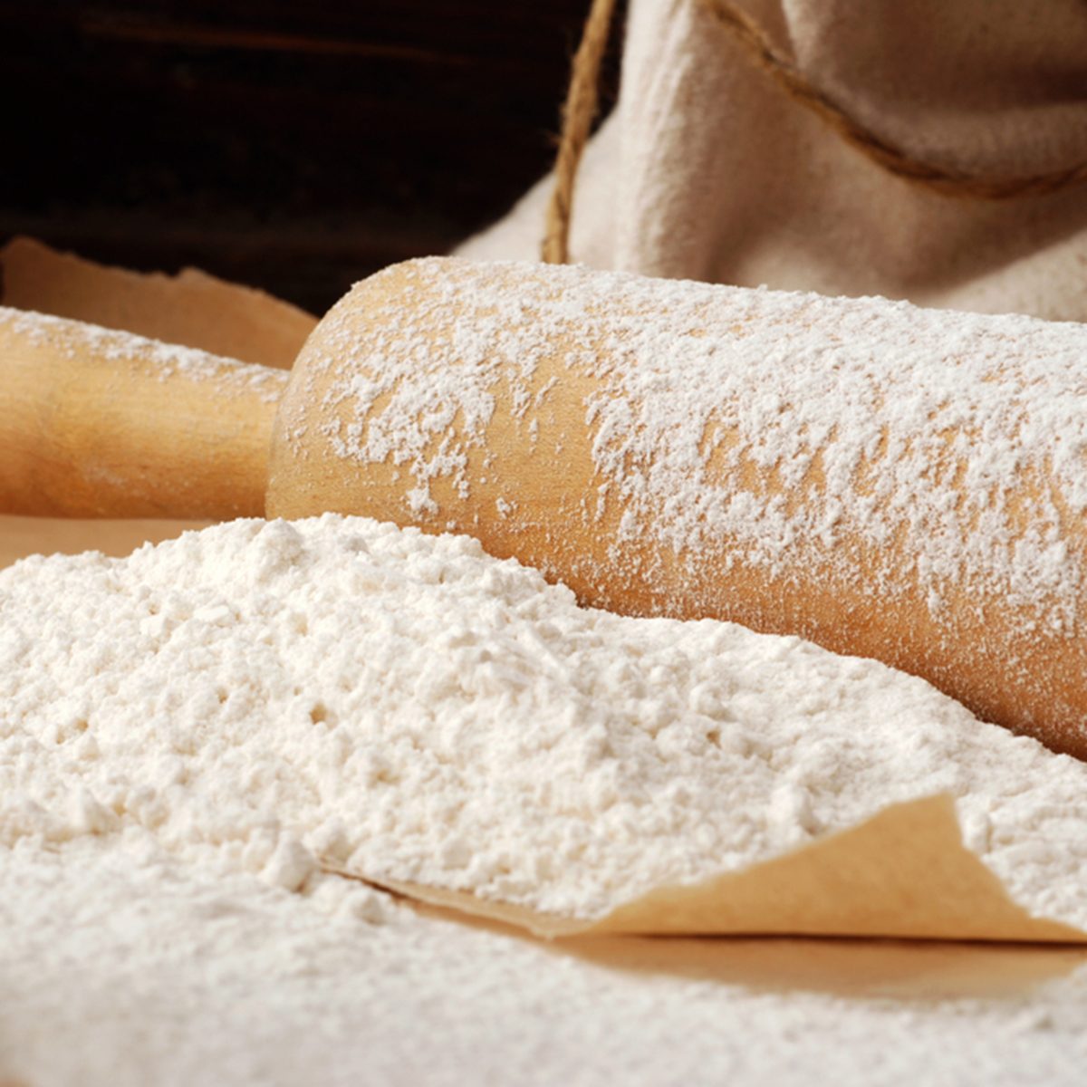Baking still-life with flour heaped onto parchment paper