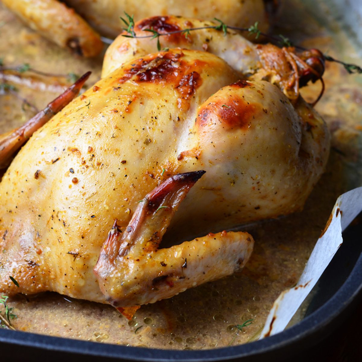 Whole Roasted Chicken with sauce on baking tray