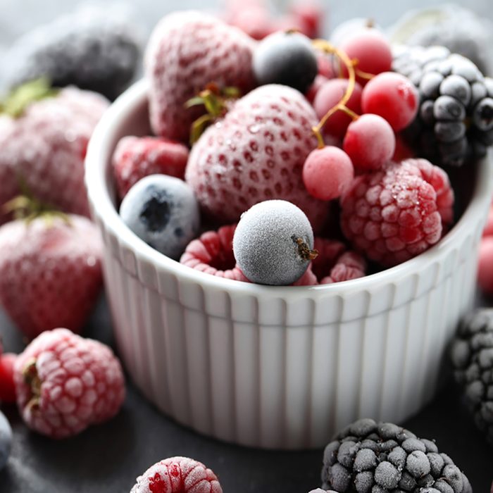 Frozen berries on a black wooden table