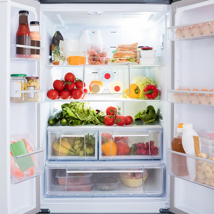 Open Refrigerator Filled With Fresh Fruits And Vegetable