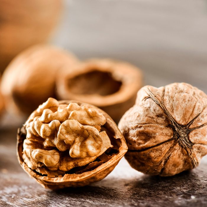 Walnuts kernels on dark desk with color background