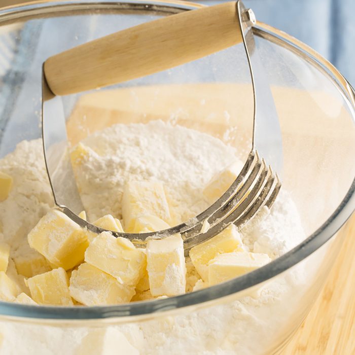 Butter in bowl with flour and handheld pastry blender.; Shutterstock ID 210190156