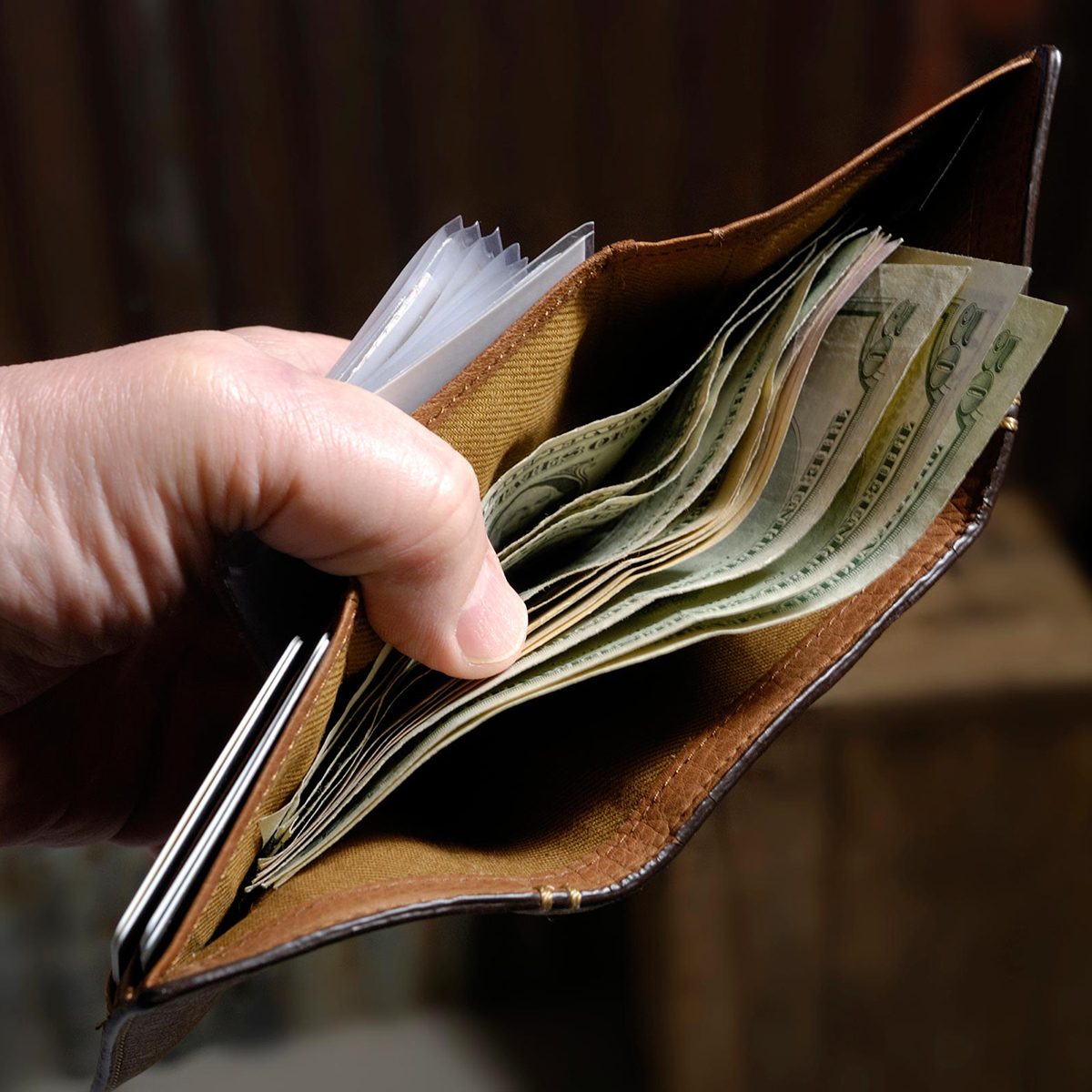 Man with wallet full of cash