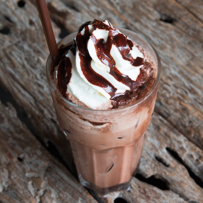 Ice chocolate with whipped cream on table