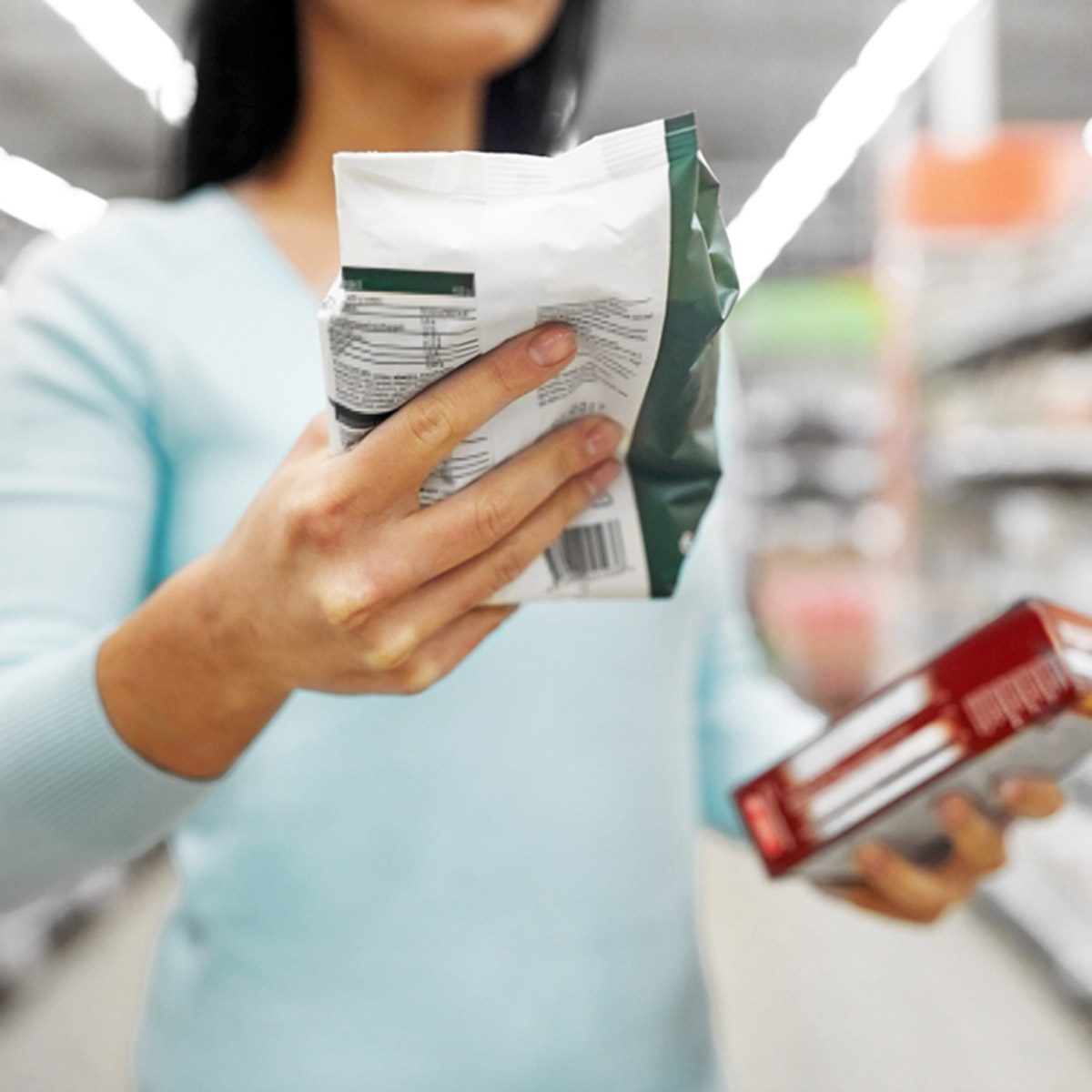 close up of woman with food at grocery store