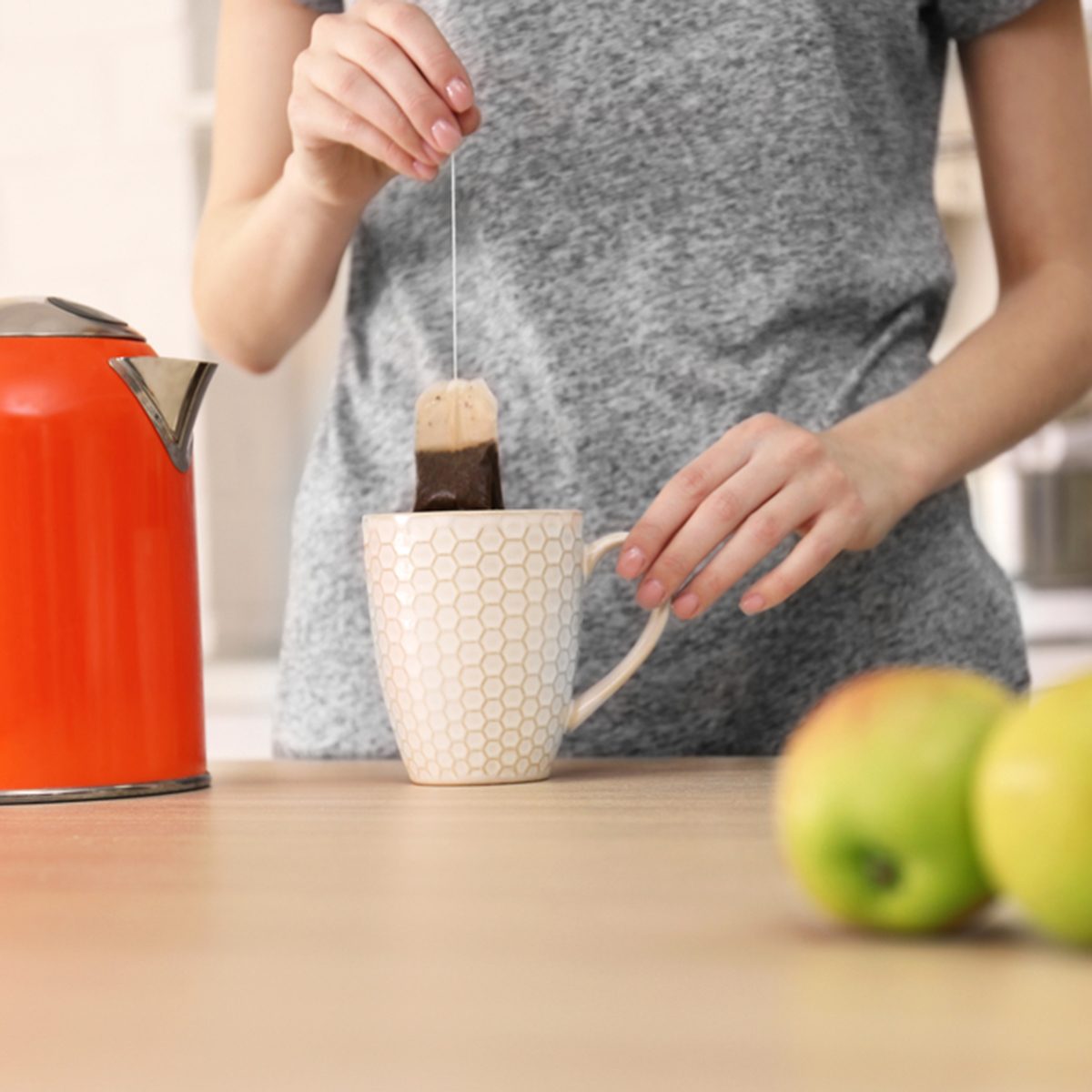 Woman making tea in the kitchen