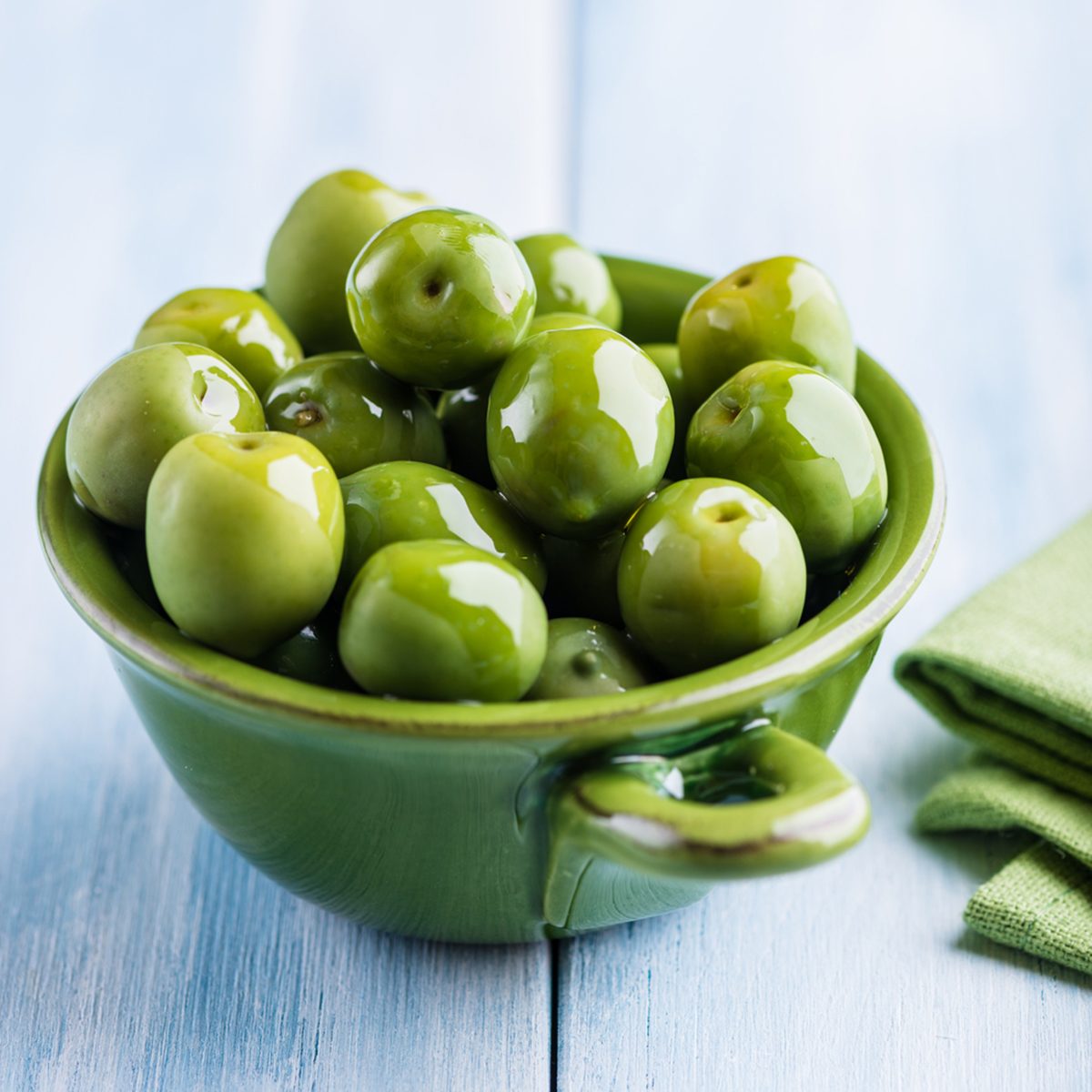 Green Sant Agostino Olives in a small ceramic bowl.