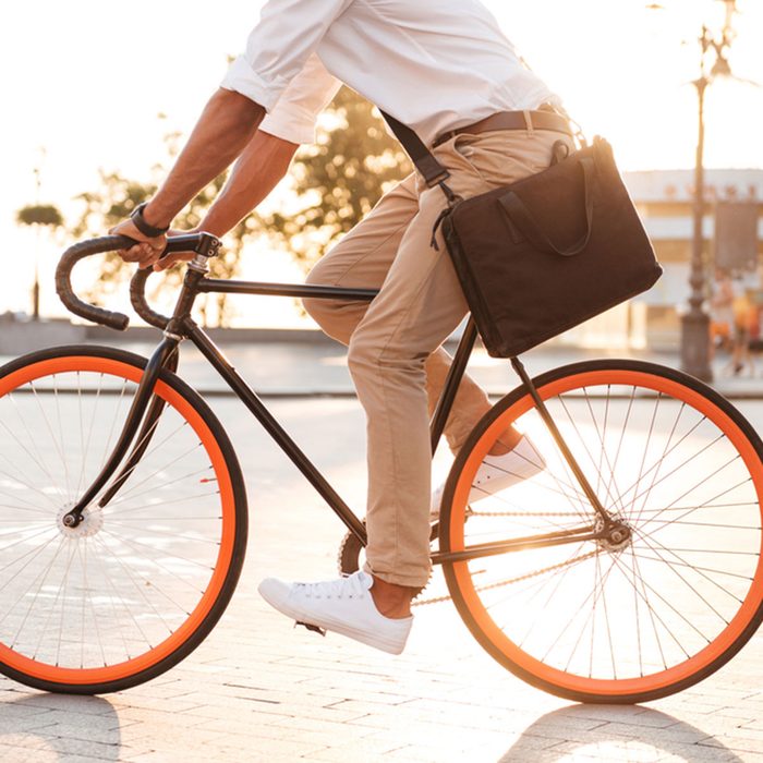 Cropped picture of handsome young african man early morning with bicycle