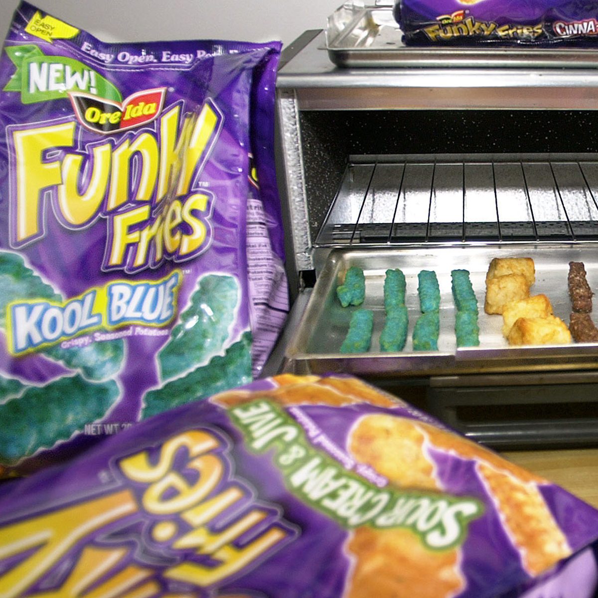 Mandatory Credit: Photo by Keith Srakocic/AP/REX/Shutterstock (6456698a) BAKED FUNKY FRIES Packages of the new "Funky Fries" that the H.J. Heinz Co. is marketing through their Ore-Ida brand surround a toaster oven with the "Kool Blue," left, "Crunchy Rings," center, and "Cocoa Crispers," right, varieties prepared in Pittsburgh, . Beginning in May, H.J. Heinz Co. will ship a new line of Ore-Ida frozen potato products called 