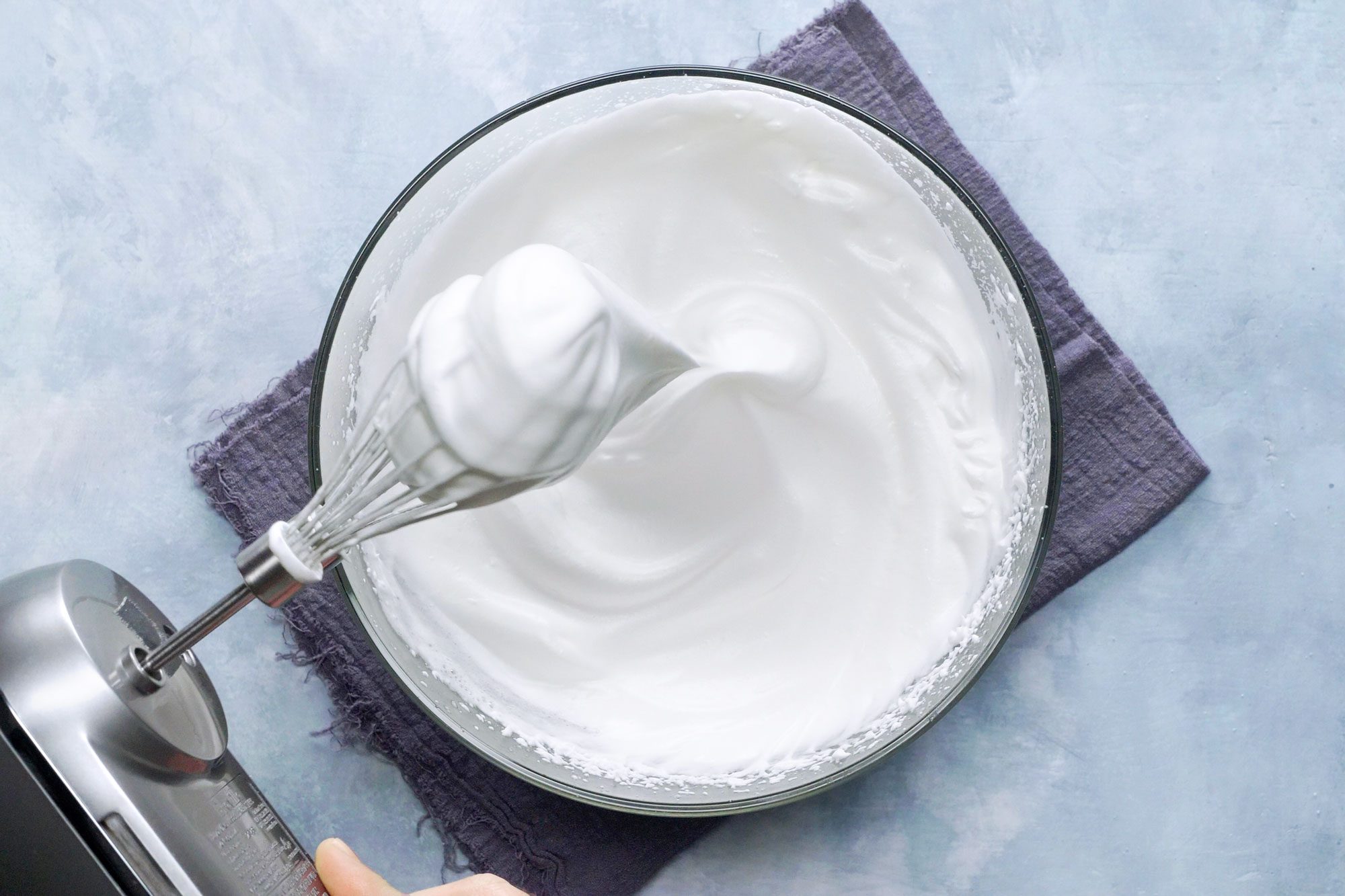 meringue in a bowl with mixer nearby