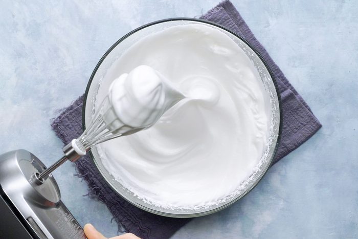 meringue in a bowl with mixer nearby