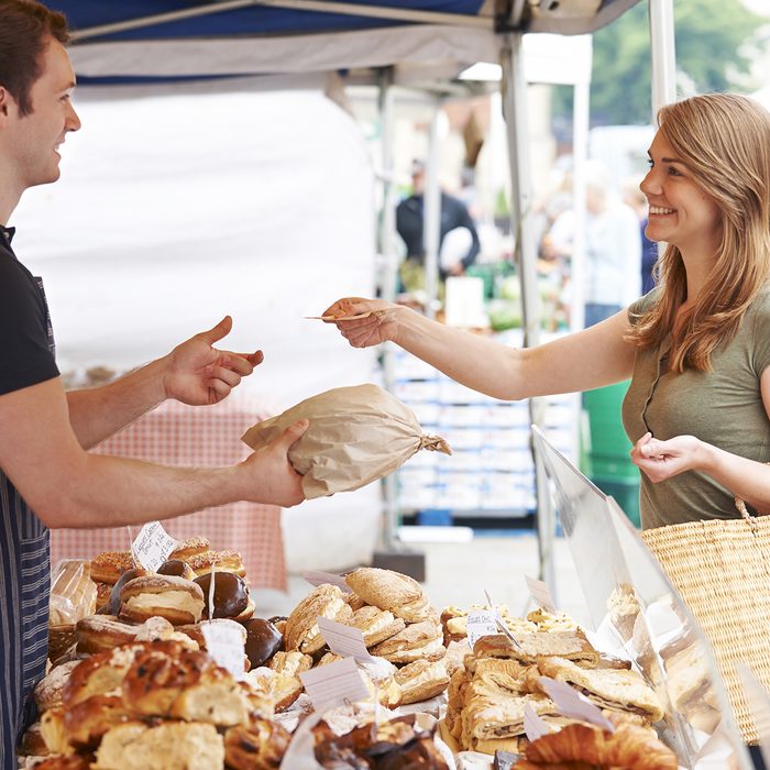 Woman Buying Bread From Market Stall