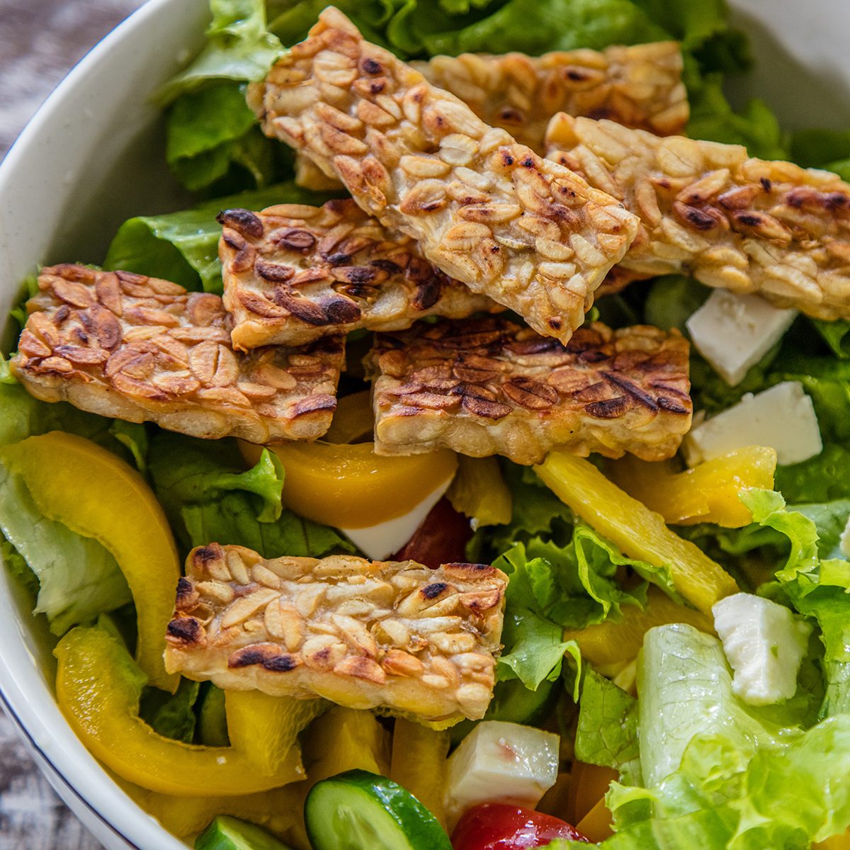 Raw vegetable and lettuce salad with tempe goreng, fried tempeh,