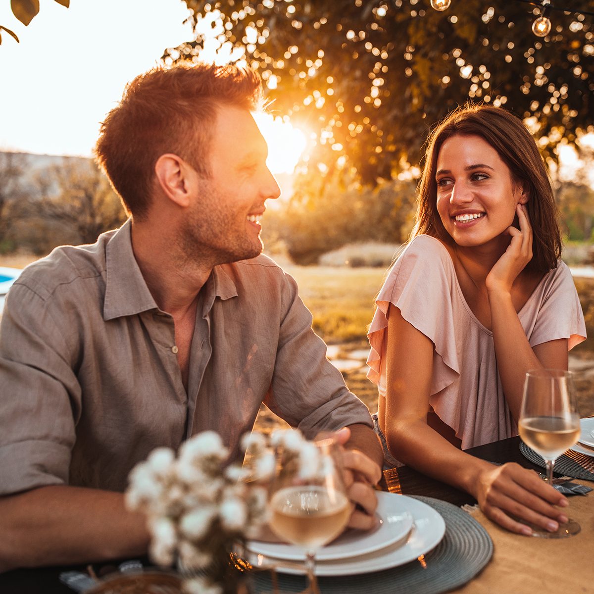 Cropped shot of a handsome couple having a romantic dinner in the backyard