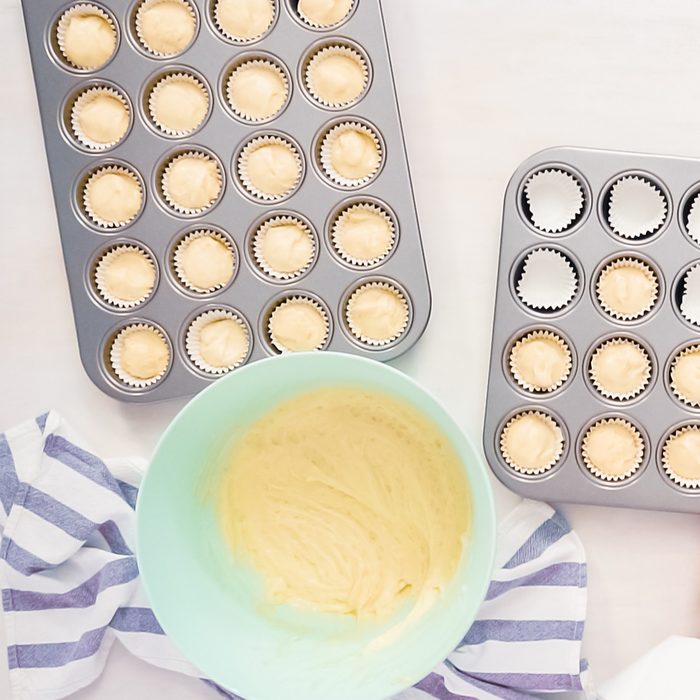 Flat lay. Scooping vanilla cupcake batter into cupcake liners.; Shutterstock ID 1235337202; Job (TFH, TOH, RD, BNB, CWM, CM): TOH