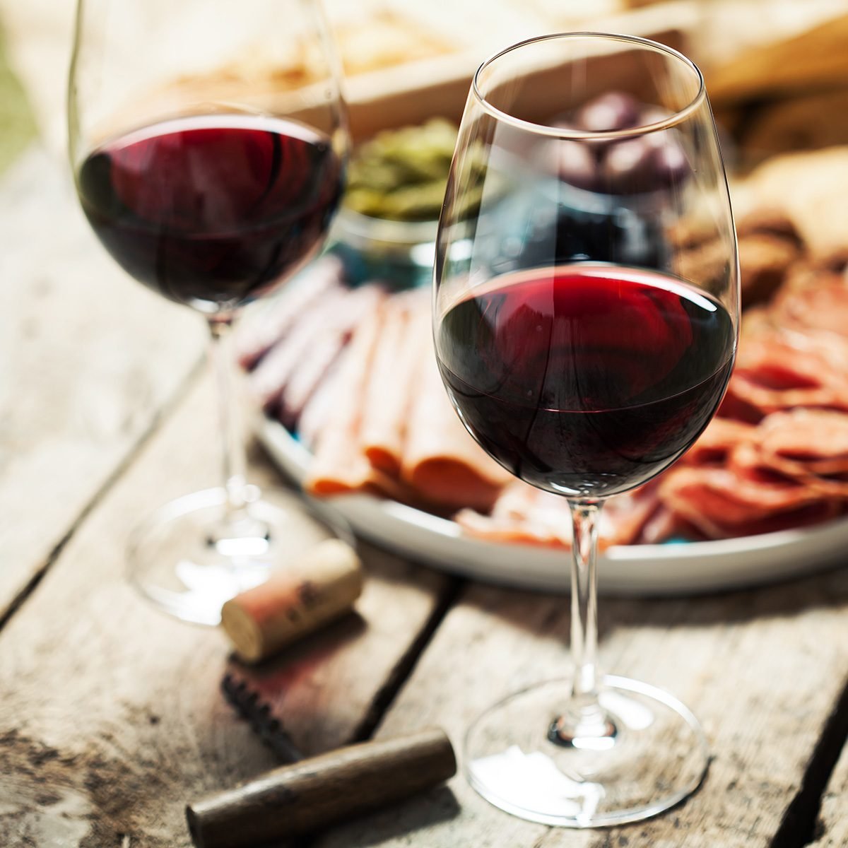 Red wine with charcuterie assortment on the background