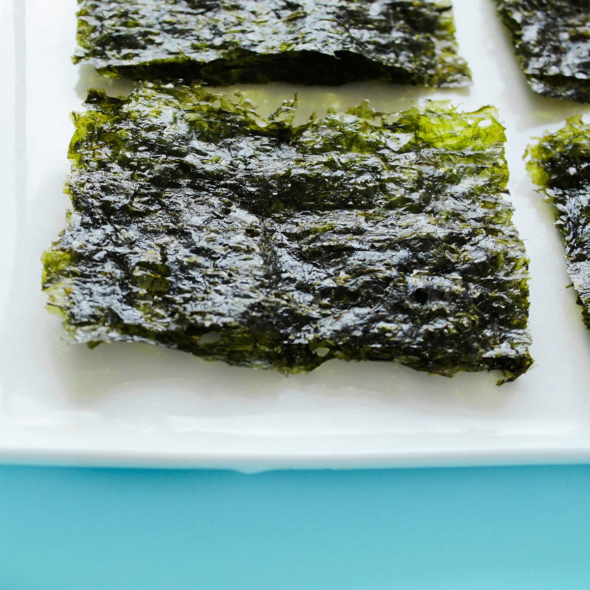 Dry korean organic seaweed isolated on blue background.