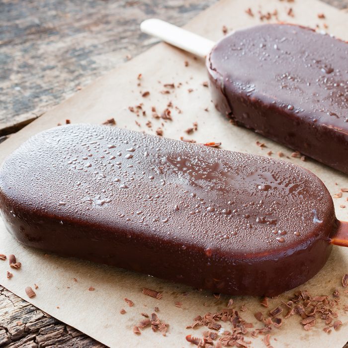 popsicle with grated chocolate on a wooden background
