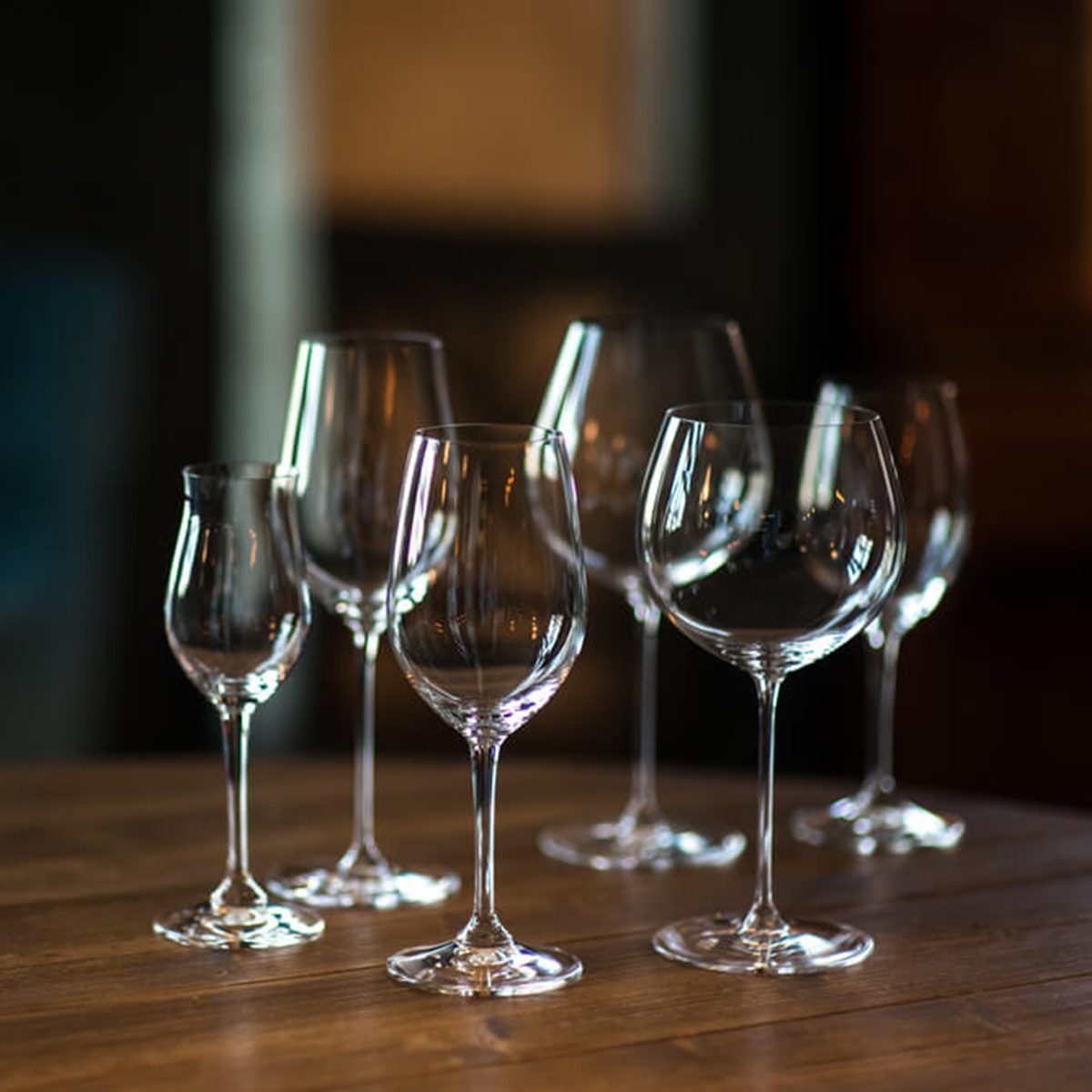 Different types of glasses for wine on wooden table. Still life concept.; Shutterstock ID 605362292
