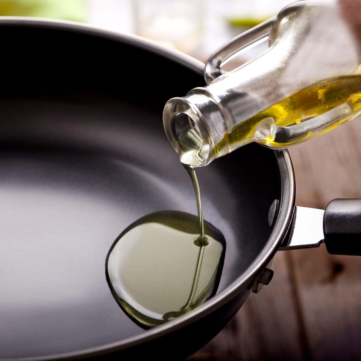pouring eating oil in frying pan