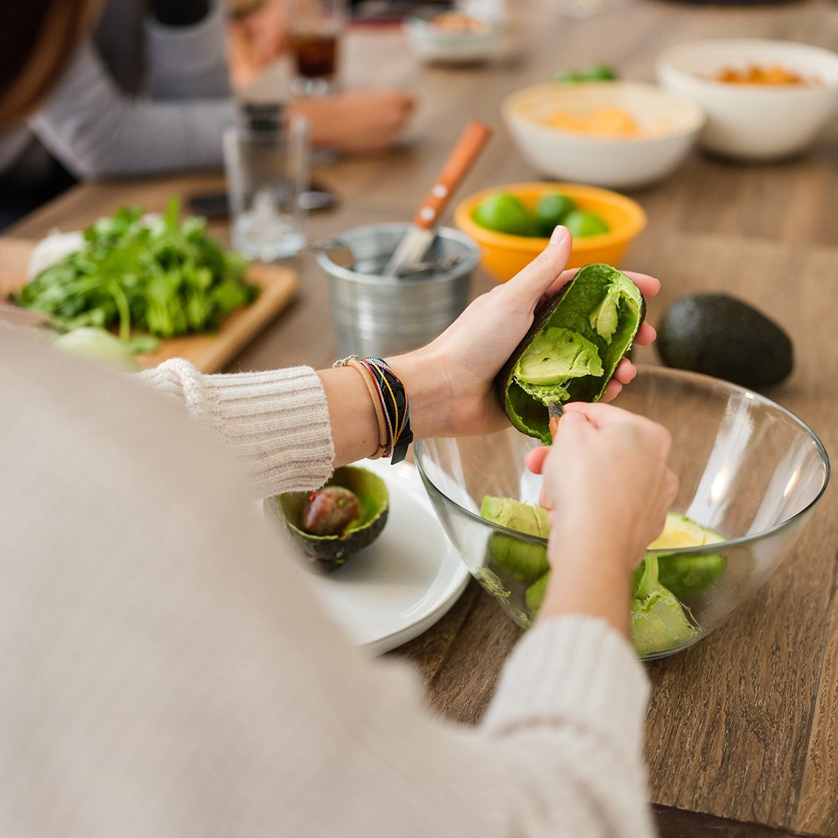 Over the shoulder view of latin woman making guacamole