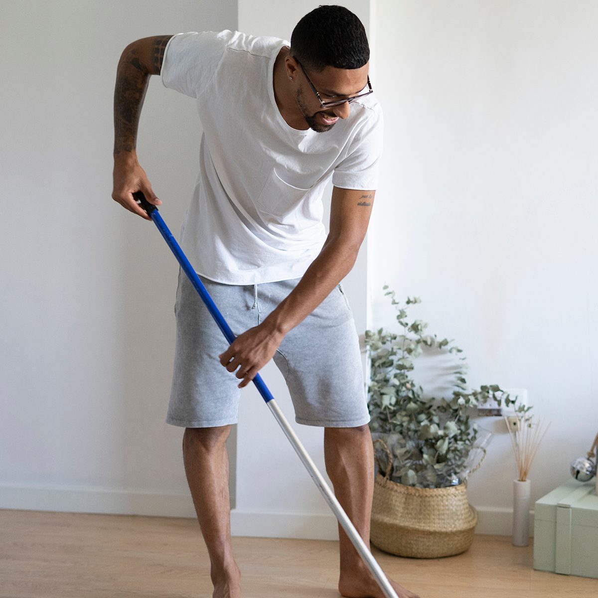 Young man wiping the floor