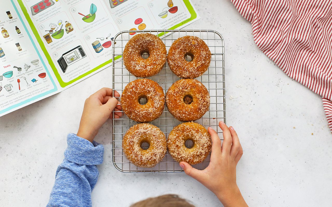Finished donuts on a metal rack