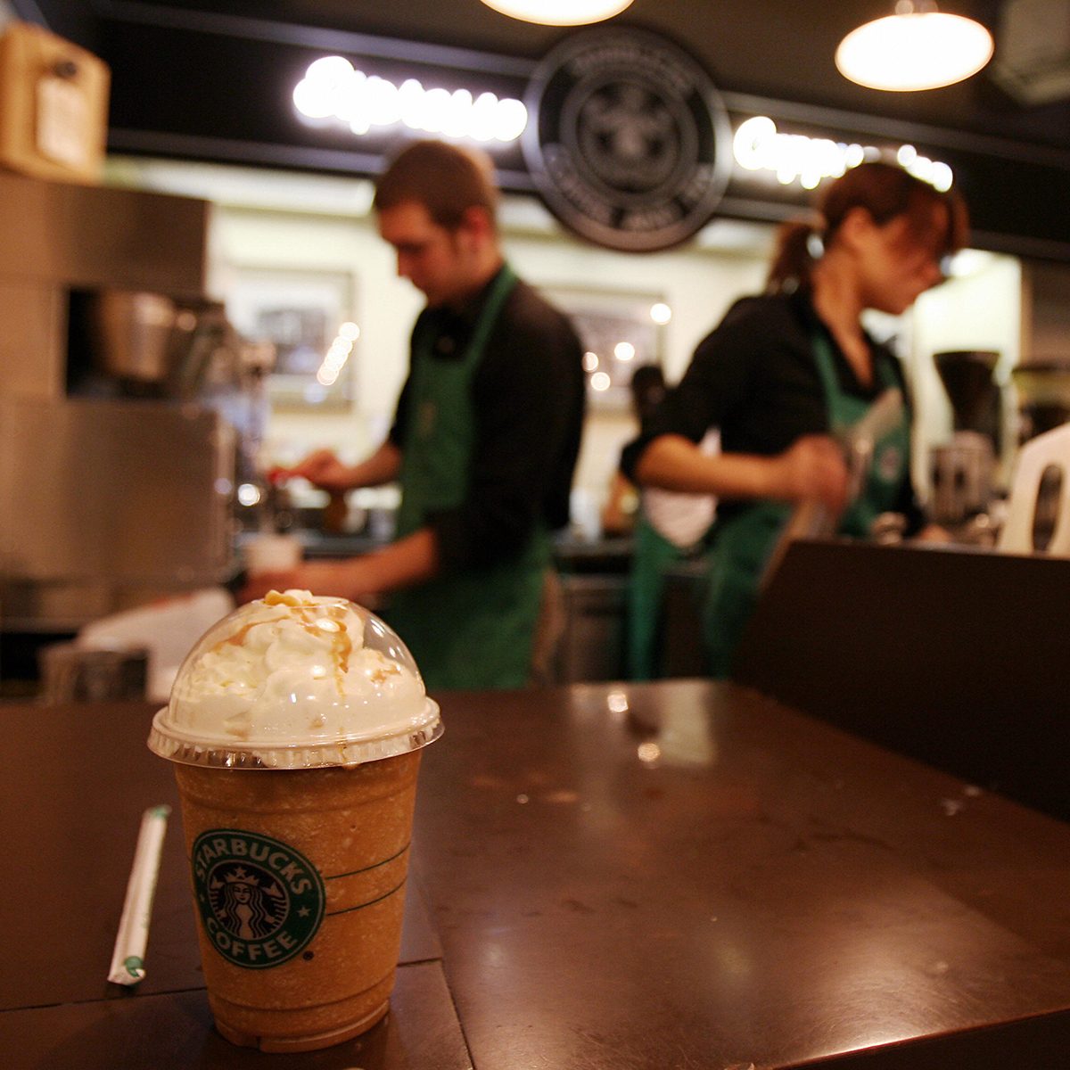 Seattle, UNITED STATES: Employees prepare beverages in the first Starbucks coffee shop in Seattle, 30 September 2006. Starbucks Corp. said it would raise most beverage prices at its US and Canadian coffee shops by five cents USD next month to help offset increased costs for fuel and labor. Starbucks opened its first location in Seattle