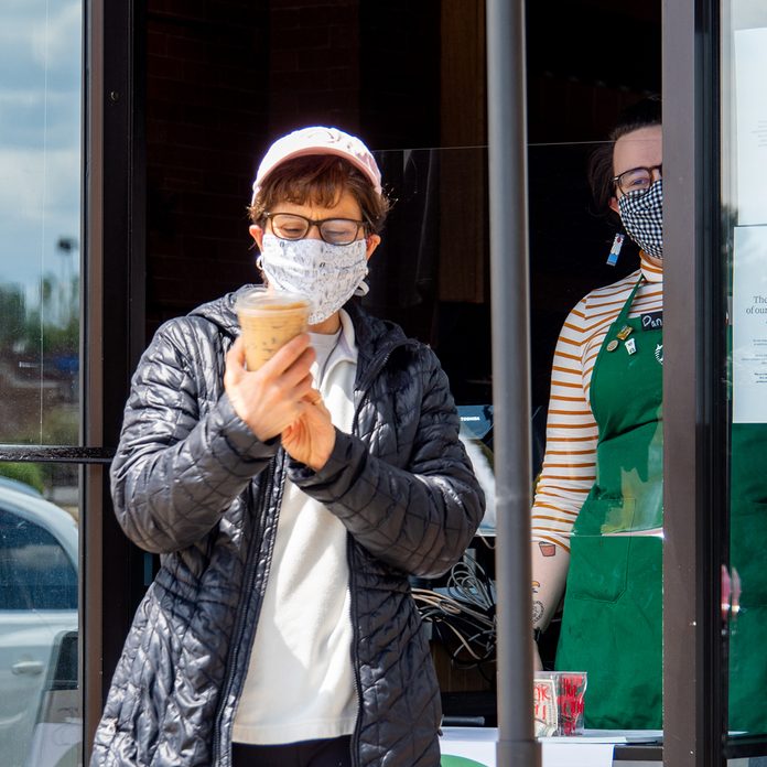 A Starbucks customer checks to ensure her order is correct as Ohio businesses reopen in the wake of the Coronavirus COVID-19 pandemic, Tuesday, May 12, 2020, in Cincinnati, Ohio, United States. (Photo by Jason Whitman/NurPhoto via Getty Images)