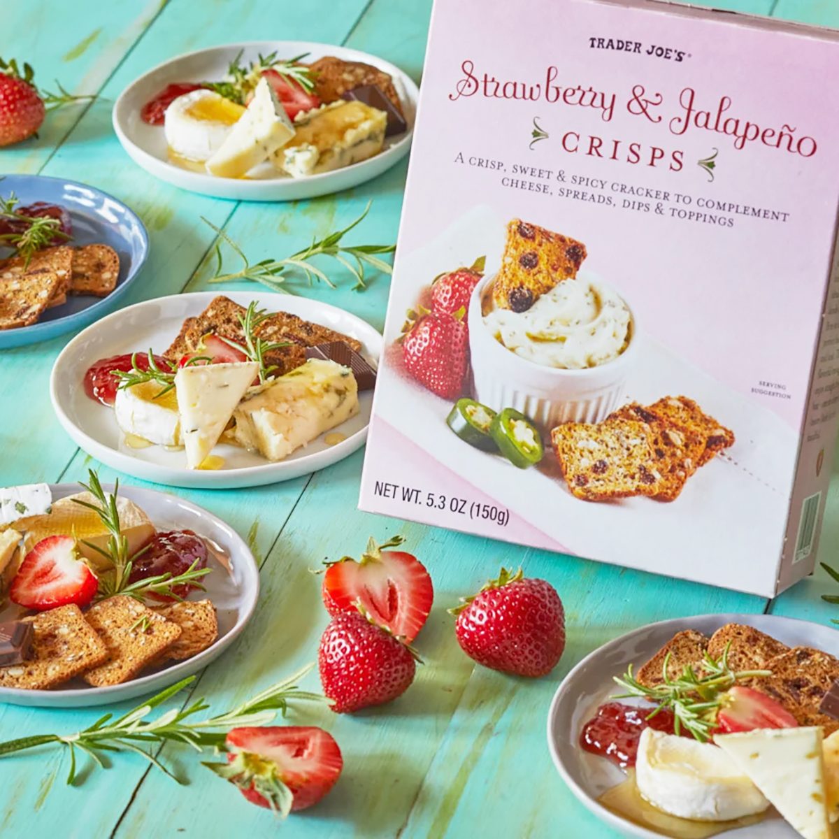 several mini plates with assorted cheese and crackers surround a box of Trader Joe