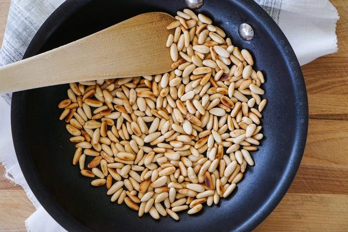 pine nuts browning in a pan