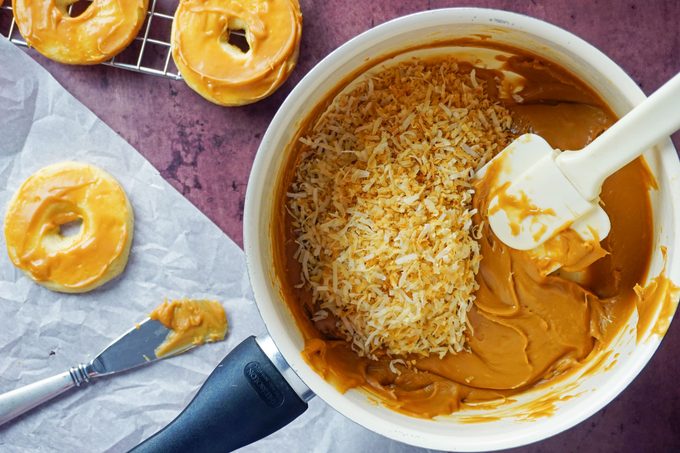 mixing toasted coconut into melted caramel
