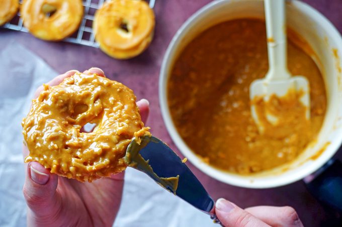 spreading coconut caramel topping onto cookies