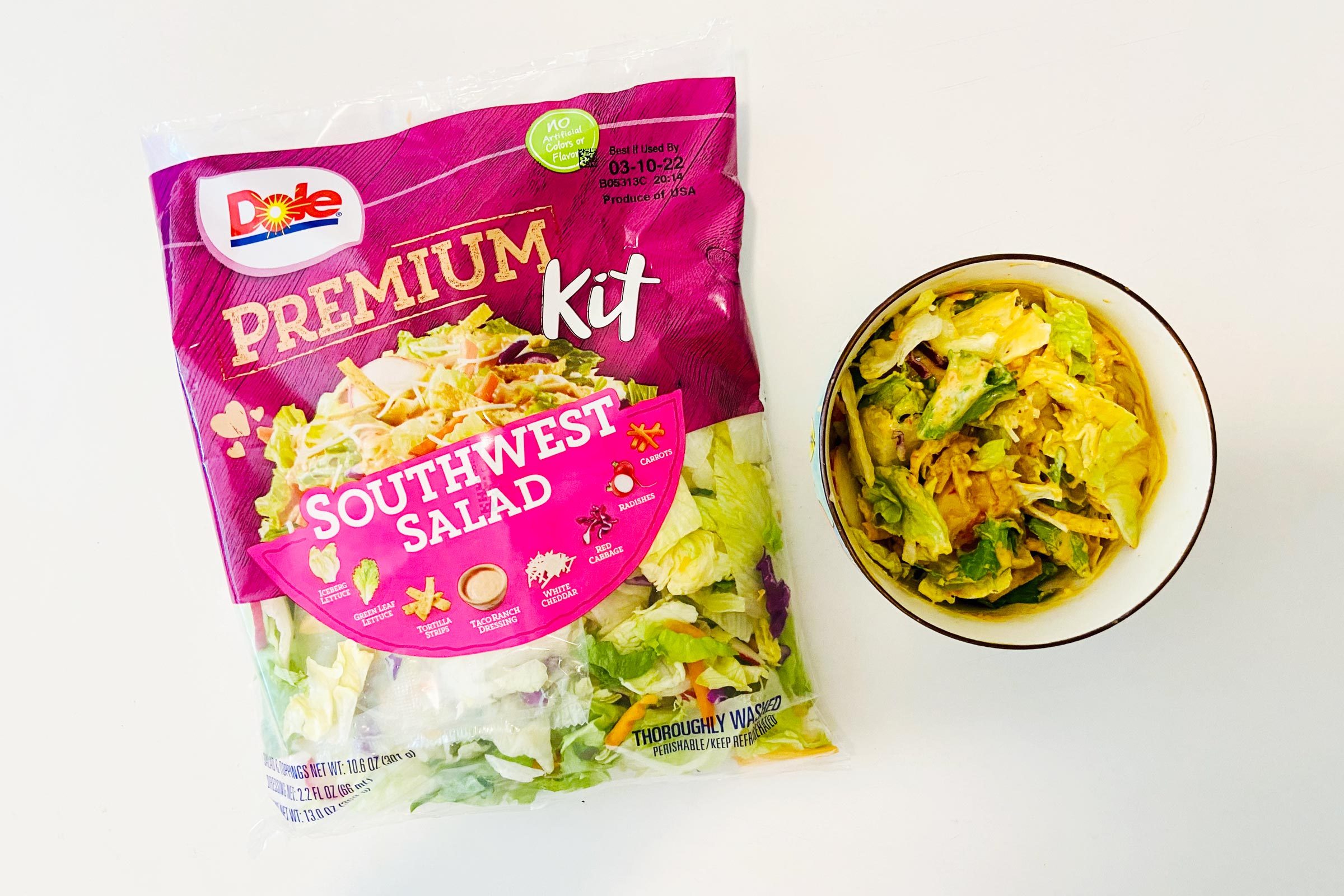 Dole salad bag with a bowl of Salad