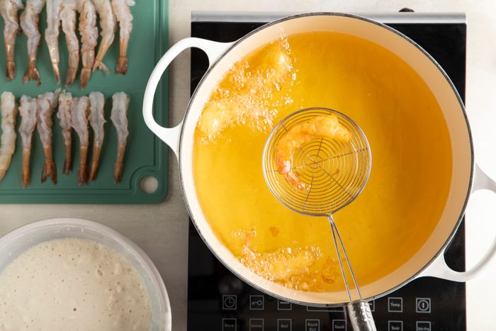 pot with hot oil frying shrimp