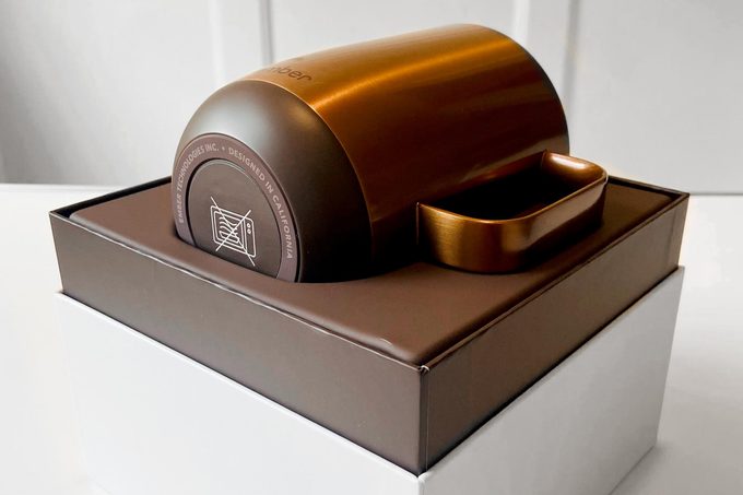 a copper ember mug in an open box on a white table in a home