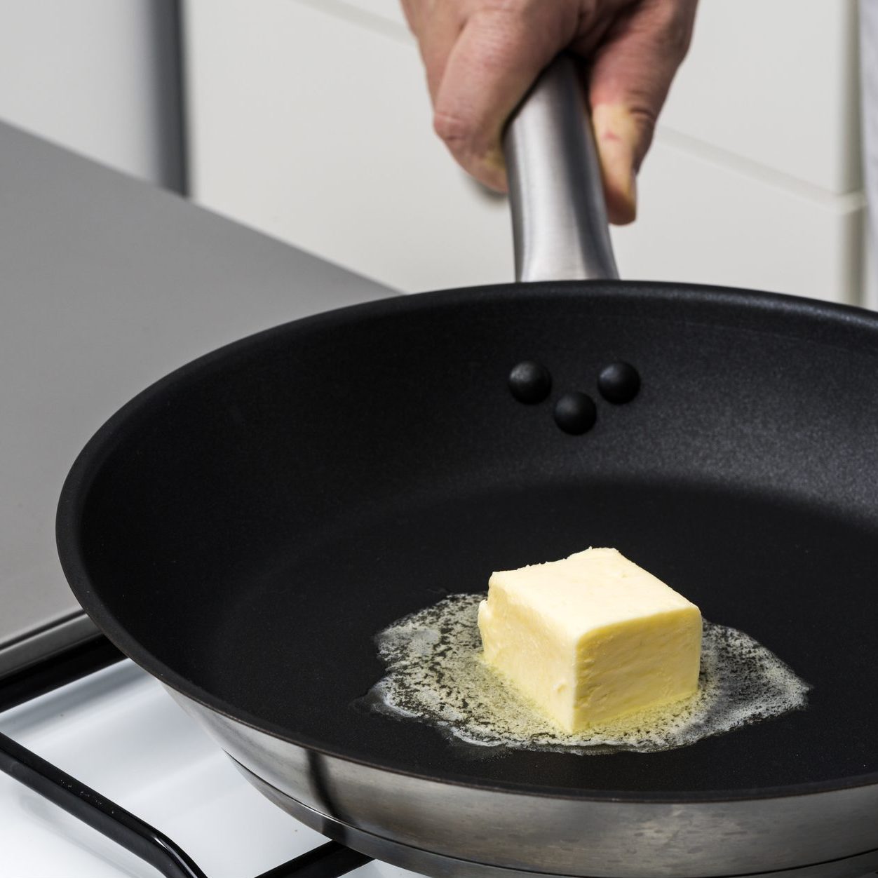 melting butter in a pan on the stove