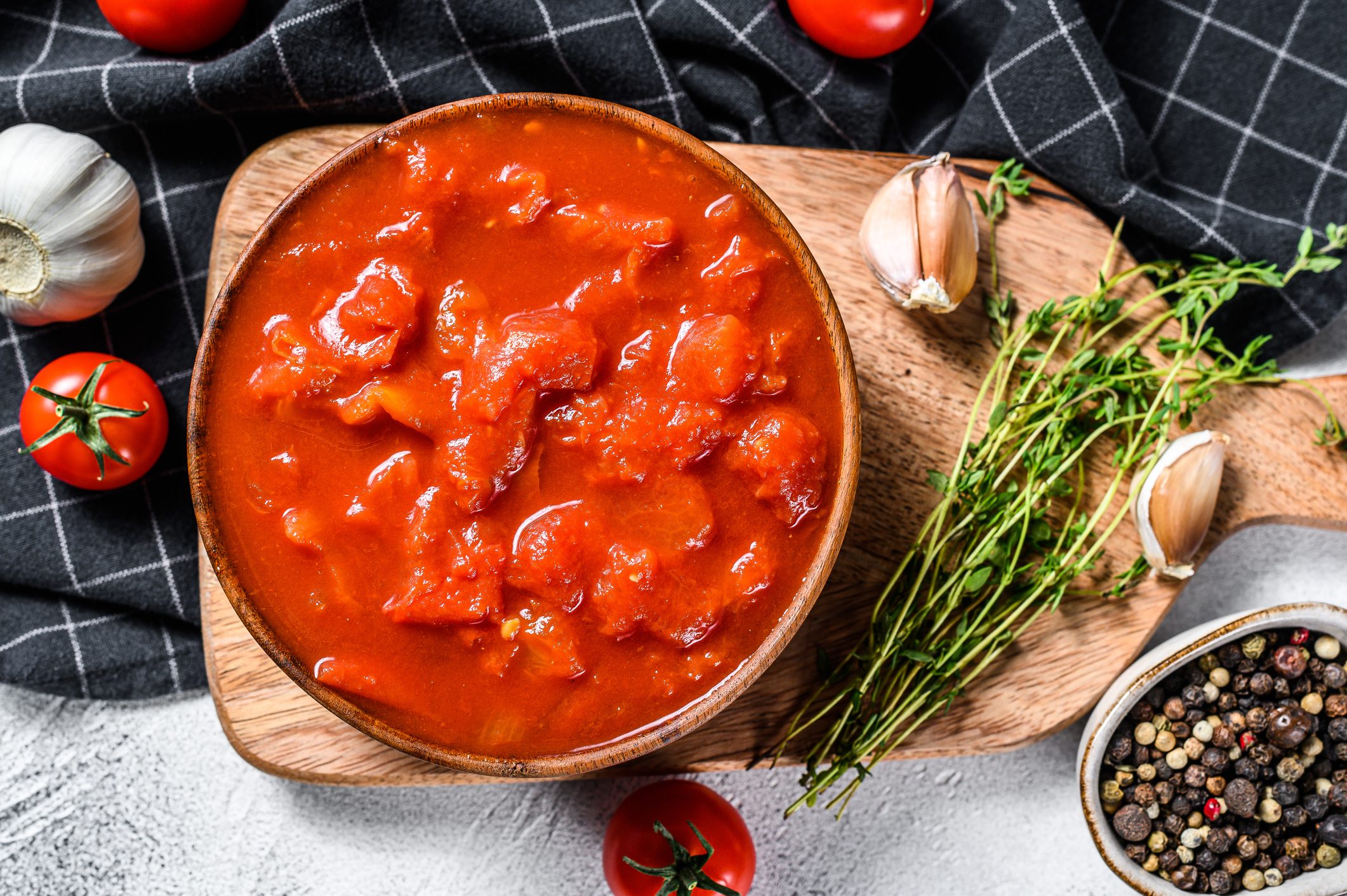Bowl of diced tomatoes isolated on rustic white surface. White background. Top view