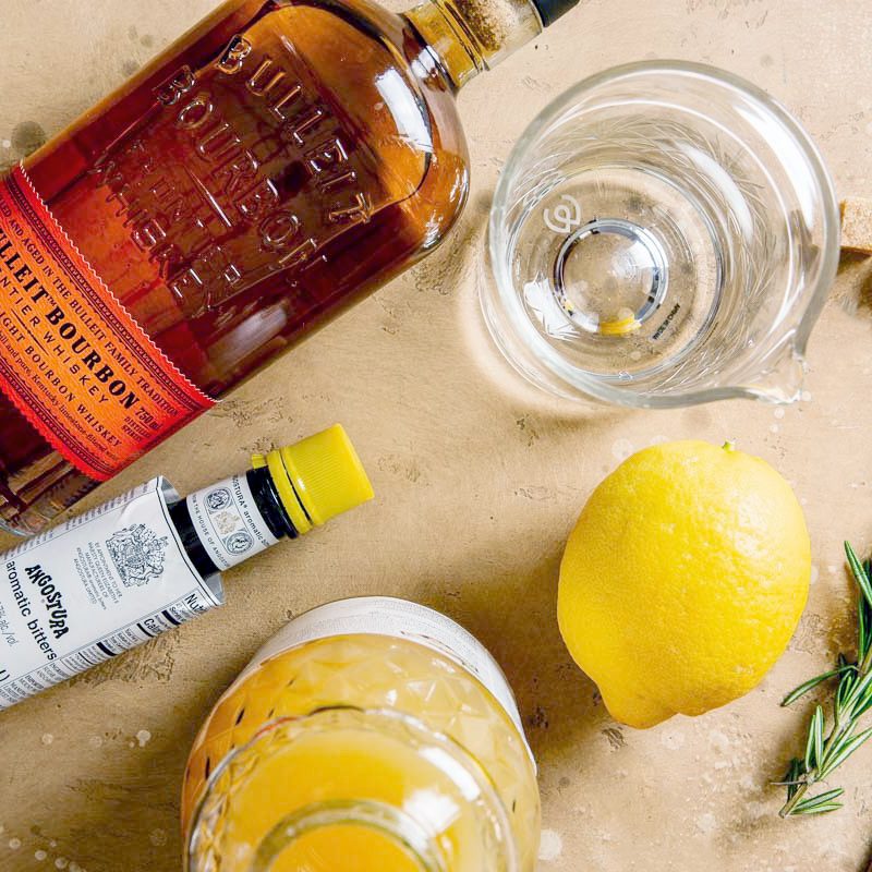 ingredients for a bourbon apple cocktail on a counter, view from above